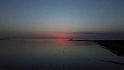 Drone Rising in 4k over a reflective body of water Stock-Footage 336235871