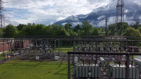 Drone rising above electrical substation and high voltage transformers Stock Footage 335038354