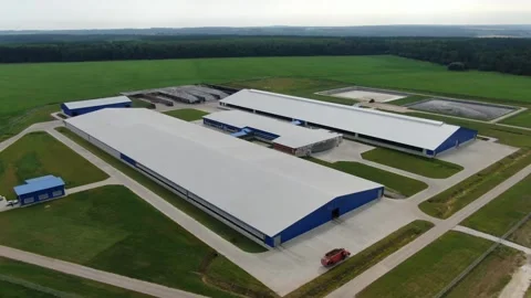 Drone rising above large farm buildings and fields Stock Footage 333082445