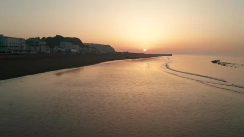 Drone rising above sandy beach at sunrise Stock Footage 342975260