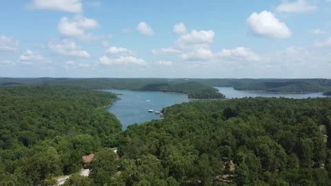 Drone rising above trees to show a river with an inlet and dock Stockbeeldmateriaal 200981841