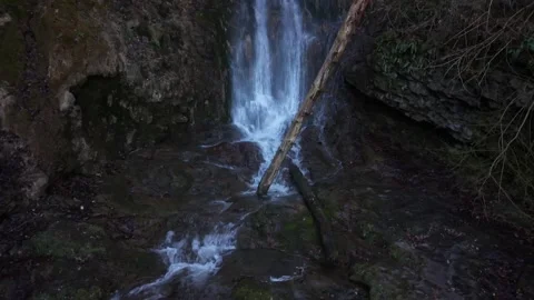 Drone rising along waterfall from river to cliff Видео 332073220