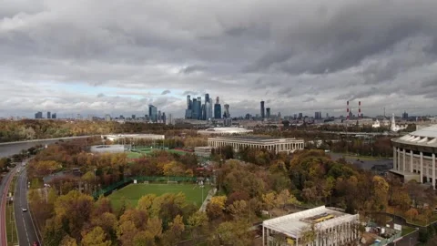 Drone rising backward above river bend and stadium Stock Footage 322933486