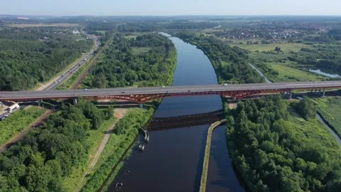 Drone rising beside elevated bridge over calm river Stock Footage 321642018