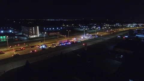Drone rising in flight over the scene of major accident at night on freeway - Stock Footage 104043353