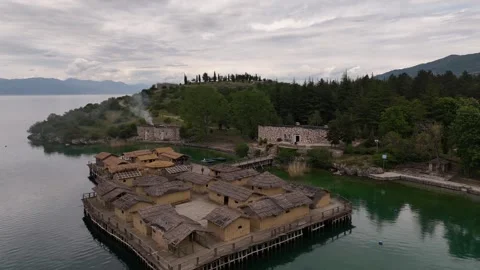 Drone Rising Forward Flight Over Bay of Bones Stilt Houses on Lake Ohrid Stock Footage 337178118