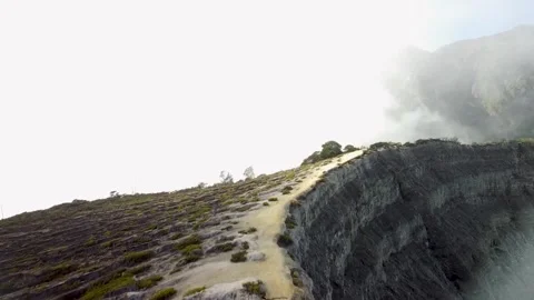 Drone Rising Forward Shot of Man Running on Volcanic Crater Stock Footage 315224370