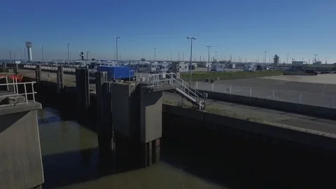 Drone rising next to sluice and campers in port of Cuxhaven Stock Footage 87380498