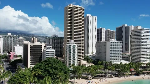 Drone Rising from Ocean Level to Skyline of Waikiki Beach in Honolulu Hawaii Stock Footage 318413079