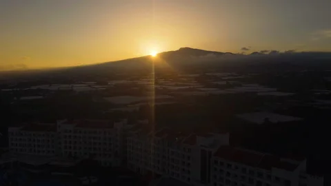 Drone rising over a hotel, toward mount Hallasan, sunset in Jeju island, South Vídeo Stock 325853474