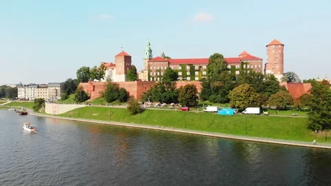 Drone rising over Vistula River, in front of Wawel Royal Castle, Krakow Poland Stock Footage 99323334