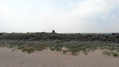 Drone rising from the sand looking over the countryside in united kingdom Stock Footage 141462547