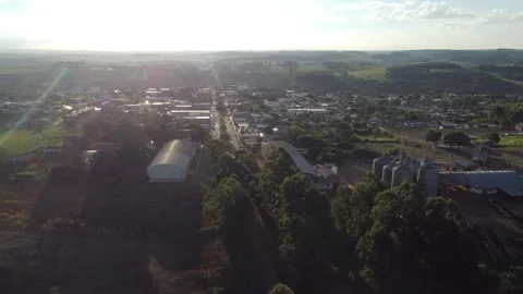 Drone rising with the sun in the background and the city of Roncador below Stock Footage 313295883