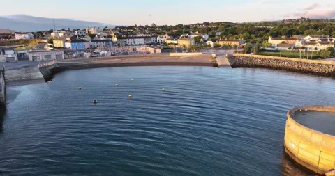 Drone rising vertically over a sheltered harbour basin and beach at Greystone Stock Footage 340325164