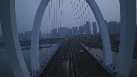 Drone Roll Shot Flying Through Aam Bridge Toward Songdo City at Dusk Stock Footage 344185677