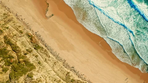 Drone rotates on 360 degrees over Beautiful  beach with white sand and roll.. Stock Footage 254623137