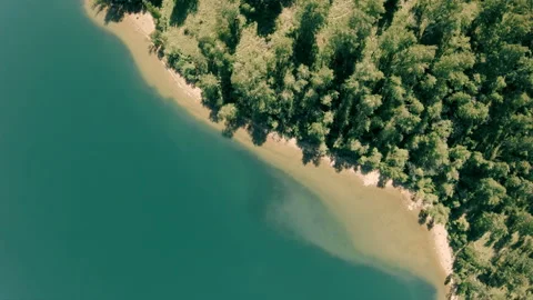 The drone rotates above the coastline. Vertical, top-down Stock Footage 103030331