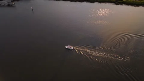 Drone Rotates around Boat at Sunset as it Idles Downriver Stock Footage 201499673