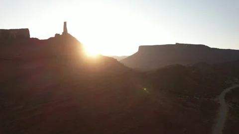 Drone rotating around Castleton Tower in Moab revealing the sunrise at 4k Stock Footage 338095125