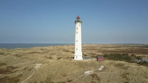Drone rotating around Danish light house and lifting Stock Footage 87254587