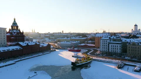 Drone rotating in front of the snowy Katajanokan kanava canal, winter in Stock Footage 328962195