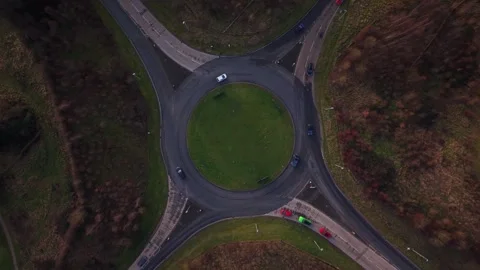 Drone rotating over UK rounabout with traffic Stock Footage 326972045