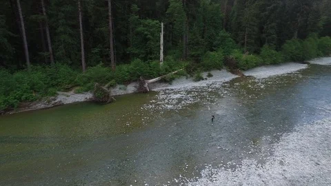  Drone Rotating Shot Man in River Stock Footage 92176271