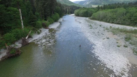 Drone Rotating Shot Man in River  Stock Footage 92176322