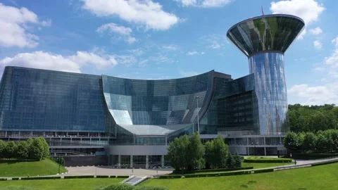 Drone rotating while descending near modern office complex Stock Footage 325985541