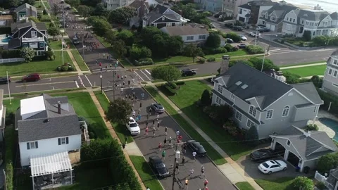 Drone runners in 5k make turn with Atlantic Ocean off to right Video stock 170778235