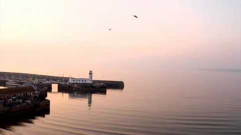 Drone of Scarborough Harbour Lighthouse Sunrise Stock Footage