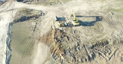 Drone scene going fast parallel to earth. From machines to lake. 스톡 동영상 52088692