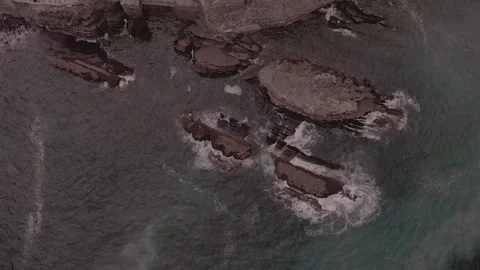 Drone sea rock from top sunset ocean black beach Stock Footage 221575053