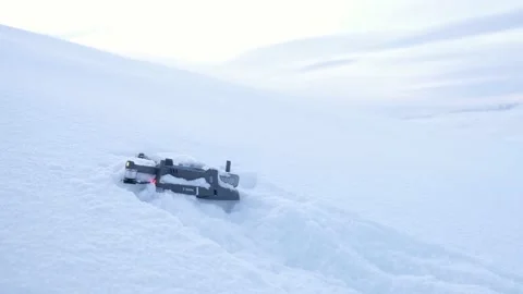 Drone is seen laying in the snow after a crash high up on a mountain 스톡 동영상 171544561