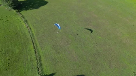 Drone shit of a Parachute flying over fields at Lake Garda with beautiful Stock Footage 286076738