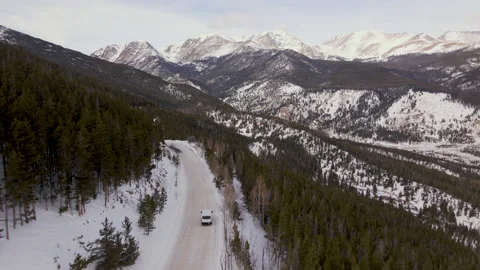 Drone Shoot Rocky Mountain Winter. Aerial shoot van driving on the snow Stock Footage 239403377
