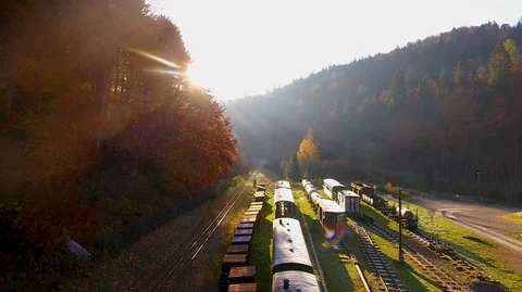 Drone shoot through mountains over a railway station Vídeo Stock 124076628