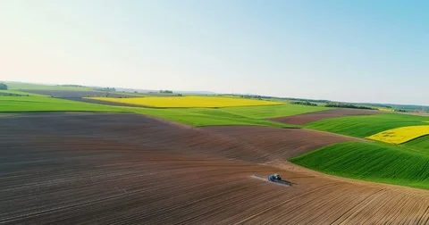 Drone shoot of tractor fertilizing soil. Video stock 75628207