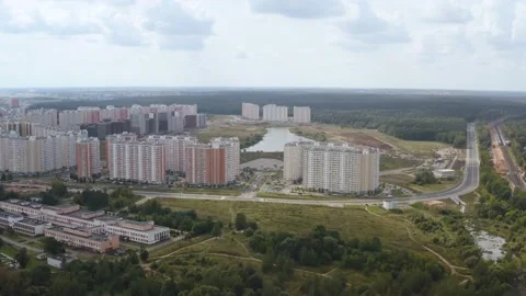 Drone shooting of a district of the city with multi-storey buildings and forest Video stock 142421655