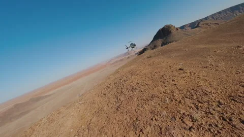A Drone Shooting a Helicopter Flying Stock Footage 295028643