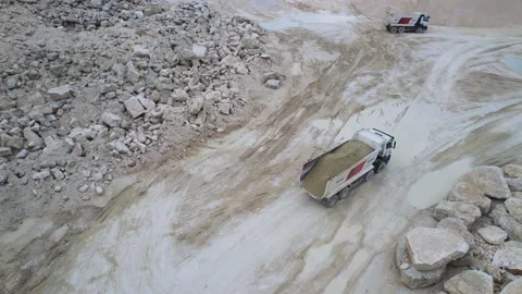Drone shooting of large dump trucks driving on sand quarry. Pit. Top view of Stock-Footage 207749250