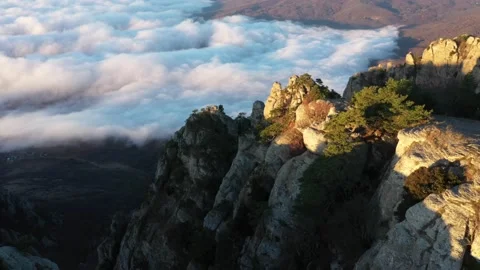Drone shooting over the peak of Mount Demerdzhi and fly high above the clouds Stock Footage 168282500