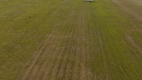 The drone shooting three gliders plane on the wing in field a sunny day Stock Footage 81547598