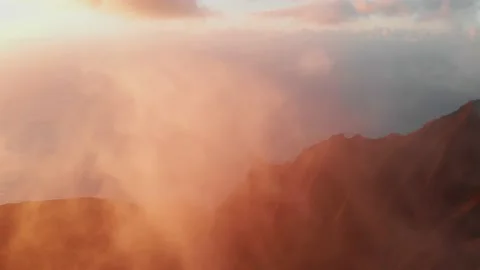 Drone shooting through the clouds over high mountain peaks and the ocean Vídeo Stock 138237982