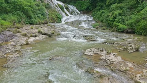 Drone shooting a turbulent three-level waterfall Stock Footage 311730686