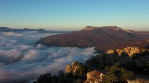 Drone shooting white clouds and peak of mountain in the autumn at dawn. Move up 스톡 동영상 168282415