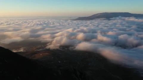 Drone shooting white clouds at the peak of the mountain at dawn 動画素材 168282601