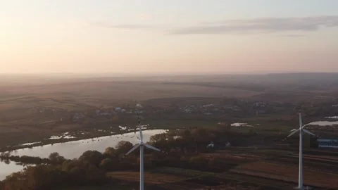 Drone shooting of wind power plants at sunrise Stock Footage 163333177