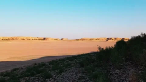 The drone shoots a man walking along a dried lake Stock Footage 235698756