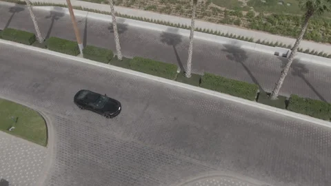 The drone shoots the movement of the car on a road Stock Footage 215475856